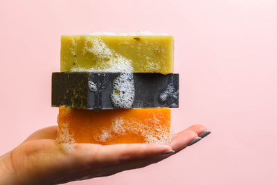 facial soap bars in hand