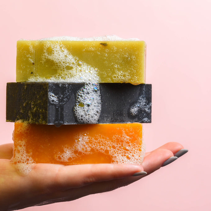 facial soap bars in hand