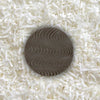 One piece of sugar-free Goalz chocolate with wavy designs lying on a bed of coconut shreds