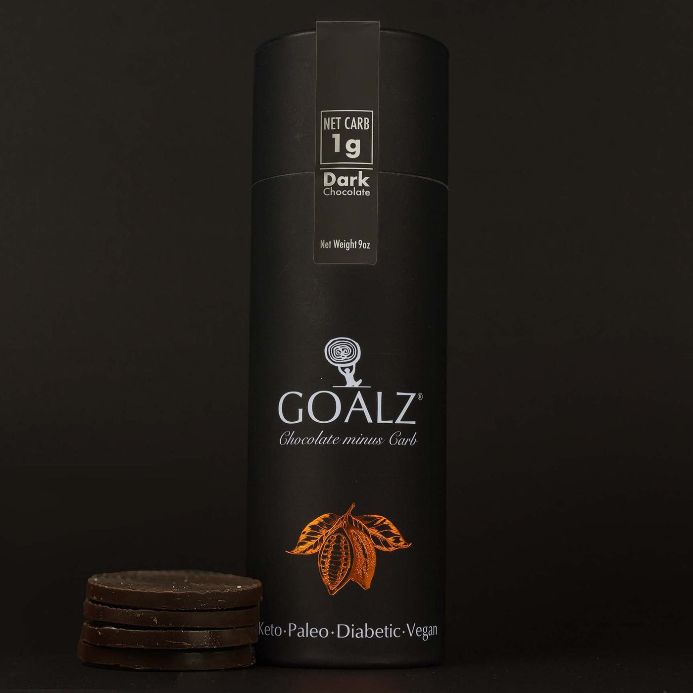 Original Allulose sweetened Goalz dark Keto Chocolate standing on a dark background and next to circular sugar-free chocolate bars stacked.