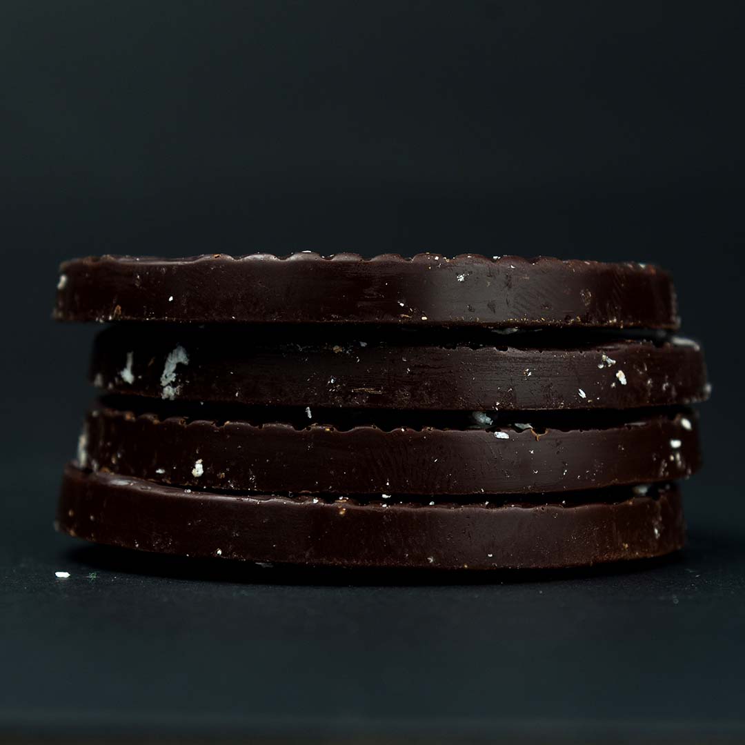 close-up photo of four stacked coconut keto chocolate mendiants